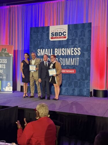 Aubri Shauger-Haley (far right) with Greg Britton, Florida SBDC State Director, and other winners.